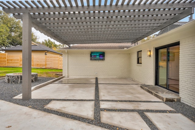 view of patio with a fire pit and fence