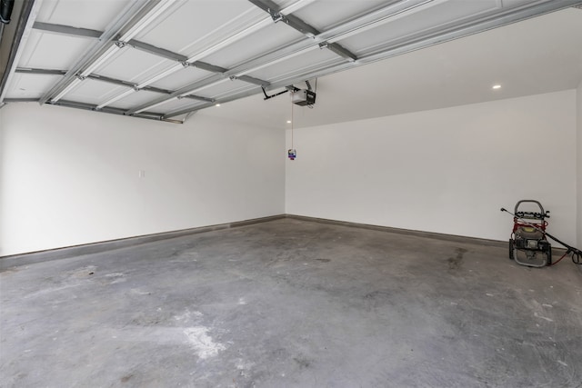 garage featuring a garage door opener and baseboards