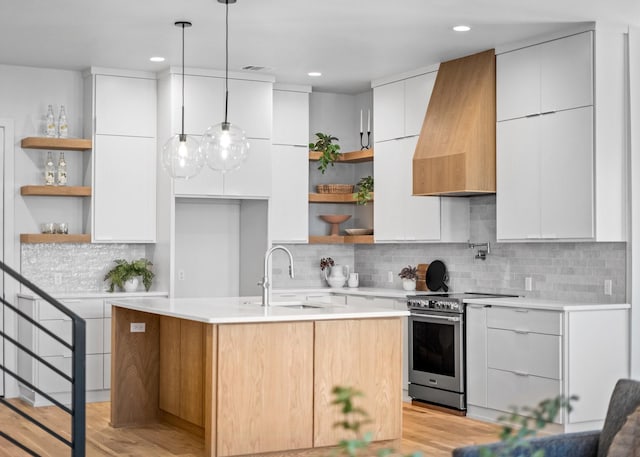 kitchen featuring modern cabinets, stainless steel range with electric cooktop, a sink, and open shelves