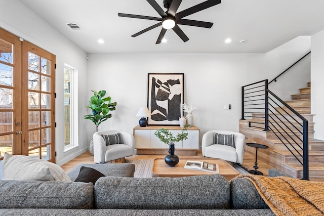 living room featuring french doors, stairway, visible vents, and recessed lighting