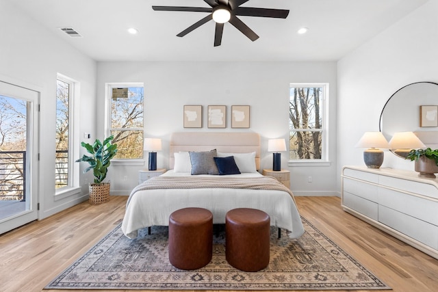 bedroom featuring access to outside, visible vents, light wood-style flooring, and recessed lighting