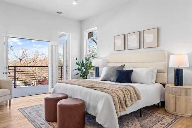 bedroom with light wood-type flooring, access to outside, visible vents, and recessed lighting