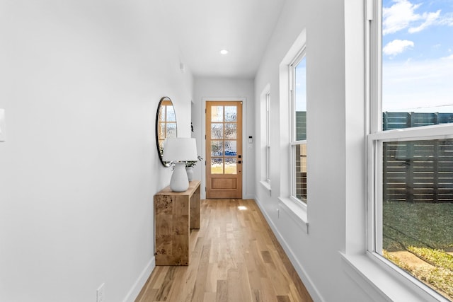 doorway to outside featuring recessed lighting, baseboards, and light wood finished floors