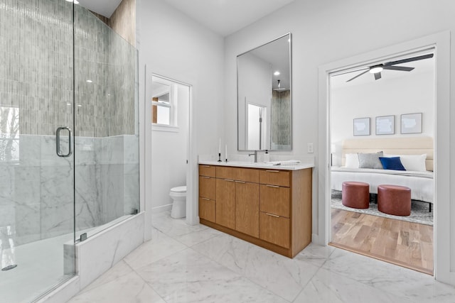 bathroom featuring marble finish floor, a stall shower, ensuite bath, and a ceiling fan