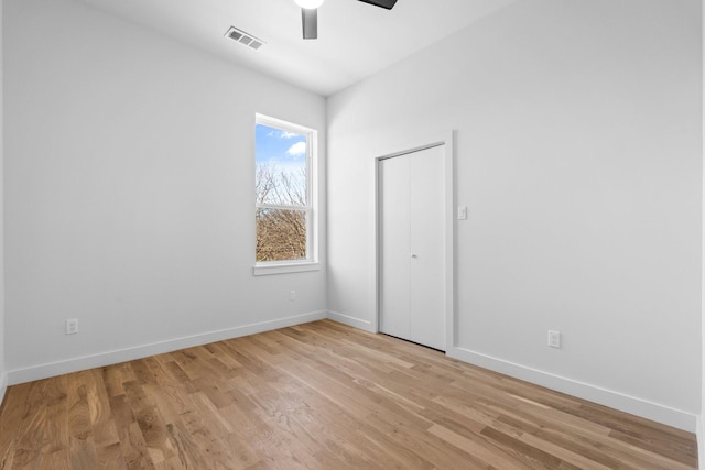 unfurnished bedroom with a ceiling fan, baseboards, visible vents, and light wood finished floors