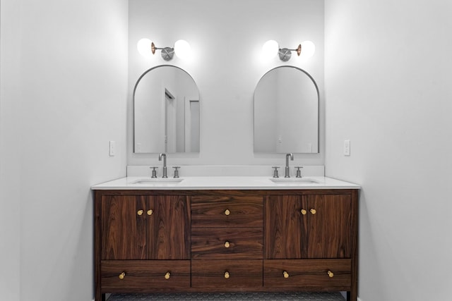 bathroom featuring a sink and double vanity