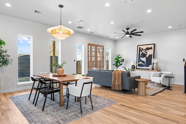 dining area with light wood-type flooring, visible vents, and recessed lighting