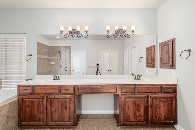 full bathroom featuring double vanity, a sink, and tiled shower