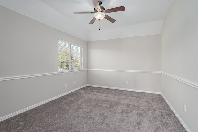 carpeted empty room with baseboards, vaulted ceiling, and a ceiling fan