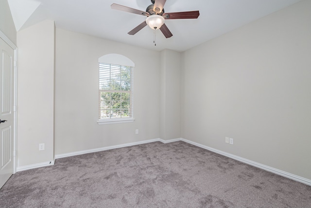 carpeted spare room with baseboards and a ceiling fan