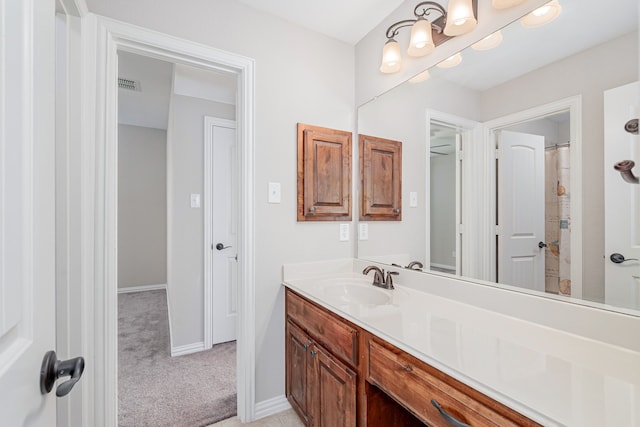 bathroom featuring vanity, visible vents, and baseboards