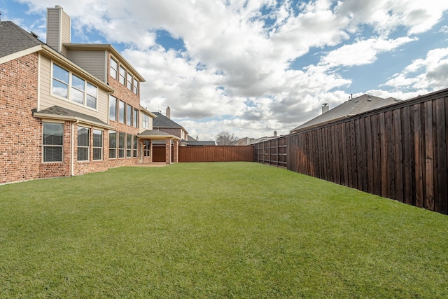 view of yard with a fenced backyard