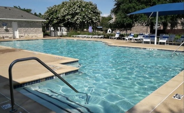 pool featuring a patio area and fence