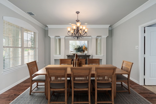 dining room with wood finished floors, visible vents, decorative columns, and an inviting chandelier