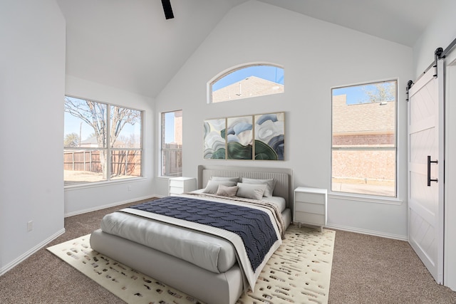 bedroom with a barn door, light carpet, ceiling fan, high vaulted ceiling, and baseboards