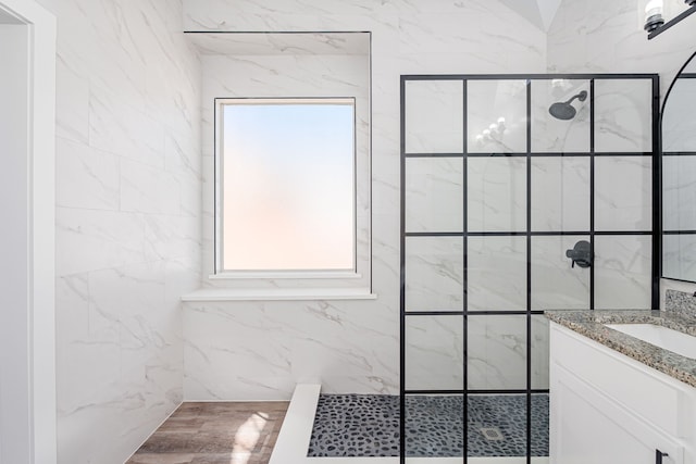 bathroom with a walk in shower and vanity