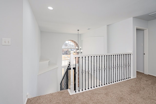 corridor featuring visible vents, baseboards, carpet flooring, a notable chandelier, and recessed lighting