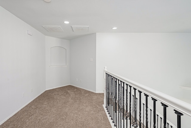 hall with baseboards, carpet floors, visible vents, and recessed lighting