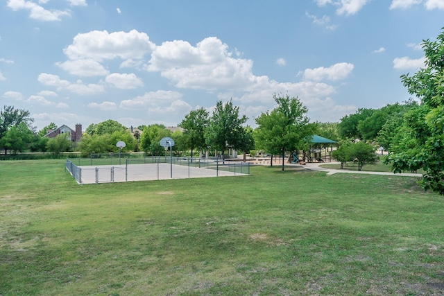 exterior space with a yard, fence, and community basketball court