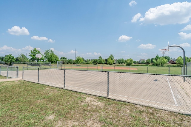 exterior space featuring community basketball court, fence, and a yard