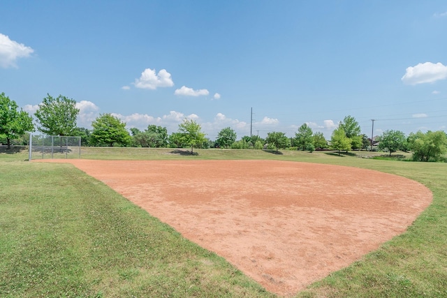 surrounding community featuring fence and a yard