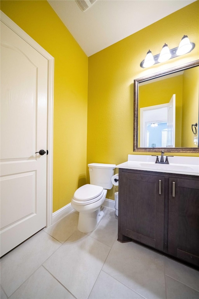 bathroom with visible vents, toilet, tile patterned flooring, baseboards, and vanity