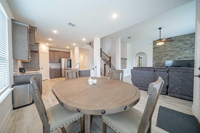 4130 Lagoon Pl, Royse City, TX 75189 - dining area with arched walkways, stairway, ceiling fan, light wood finished floors, and recessed lighting