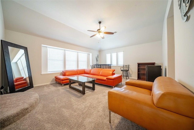 carpeted living area featuring baseboards and a ceiling fan