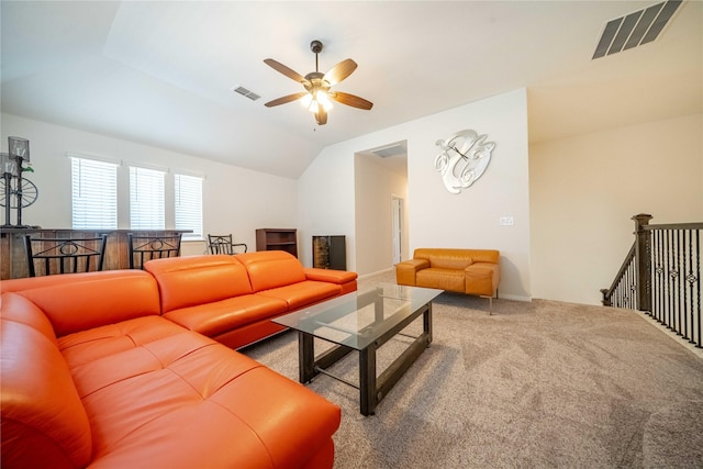 living area with visible vents, carpet flooring, lofted ceiling, and ceiling fan