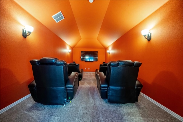 home theater featuring visible vents, carpet floors, baseboards, and vaulted ceiling