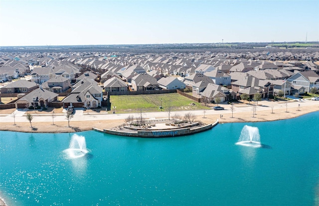 drone / aerial view featuring a residential view and a water view