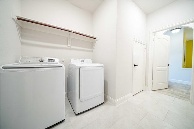 4130 Lagoon Pl, Royse City, TX 75189 - laundry room with washer and clothes dryer, baseboards, and light tile patterned flooring