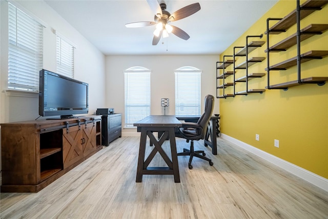 office with baseboards, light wood finished floors, and ceiling fan