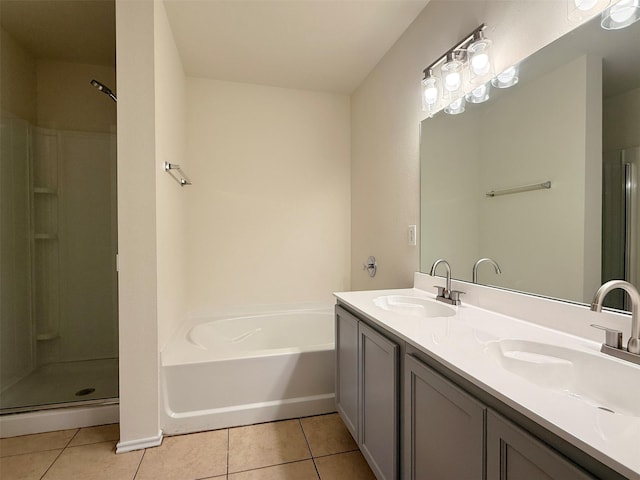 full bath with tile patterned flooring, a sink, and a shower stall