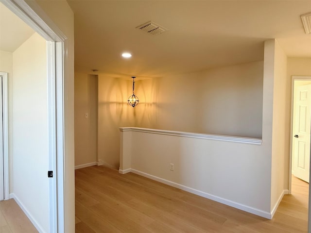 empty room featuring recessed lighting, visible vents, baseboards, and wood finished floors