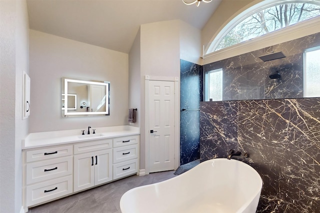 bathroom featuring lofted ceiling, a soaking tub, vanity, and walk in shower