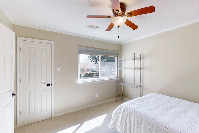 bedroom with carpet, visible vents, crown molding, and baseboards