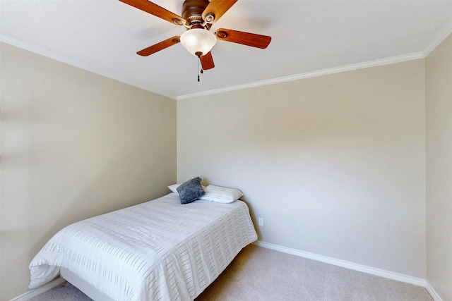 bedroom featuring a ceiling fan, baseboards, crown molding, and light colored carpet