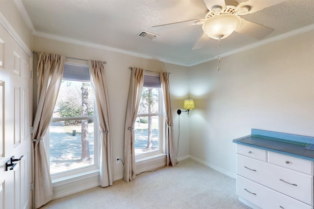 entryway featuring light carpet, a ceiling fan, baseboards, visible vents, and crown molding