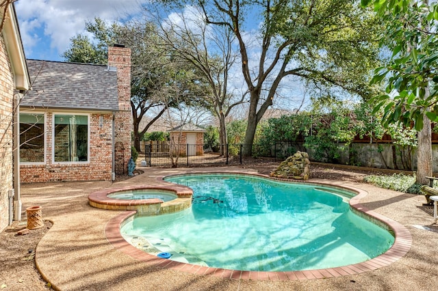 view of pool featuring a fenced backyard and a pool with connected hot tub