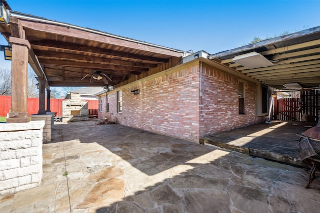 view of patio featuring ceiling fan and fence