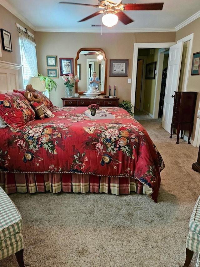 bedroom with carpet, a ceiling fan, and crown molding