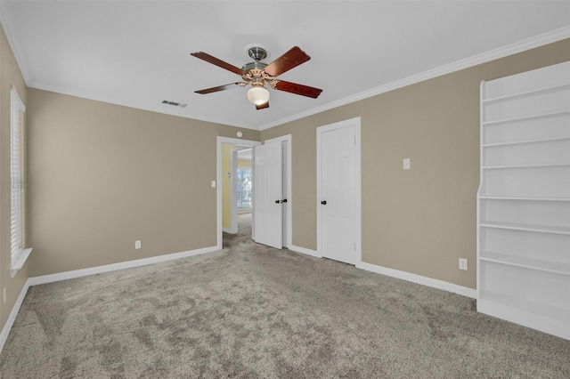 unfurnished bedroom featuring carpet flooring, two closets, visible vents, and baseboards