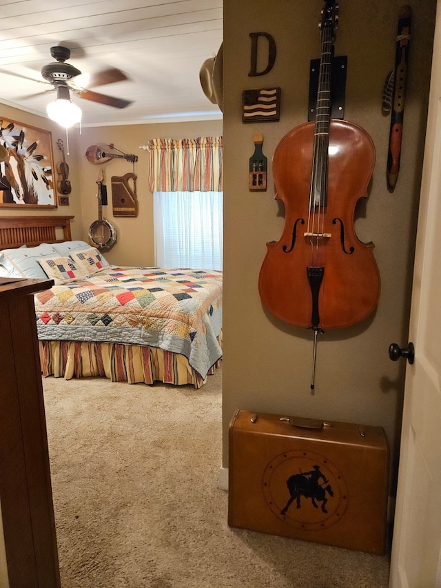 bedroom with carpet floors, ceiling fan, and ornamental molding