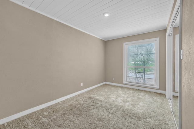 carpeted spare room with baseboards