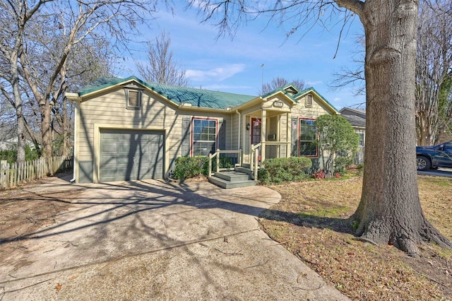 ranch-style home featuring a garage, driveway, and fence