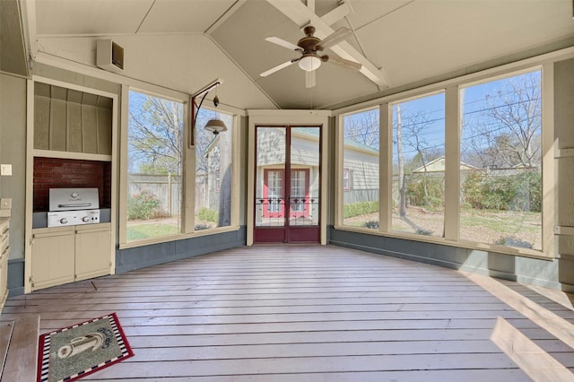 unfurnished sunroom with lofted ceiling and a ceiling fan