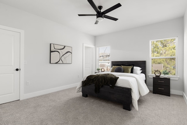 bedroom featuring baseboards, ceiling fan, and light colored carpet