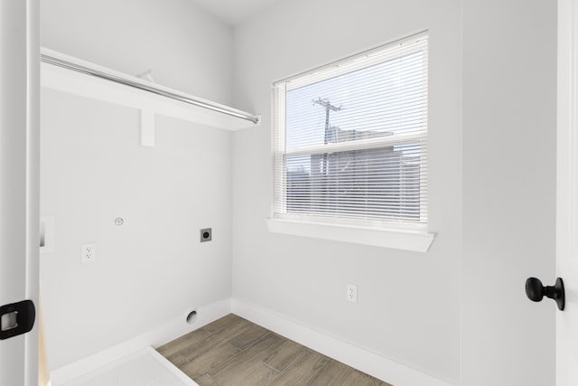 washroom with laundry area, electric dryer hookup, baseboards, and wood finished floors