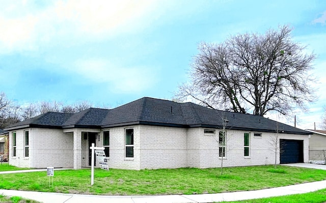5147 Chapman St, Fort Worth, TX 76105 - view of property exterior featuring an attached garage, brick siding, a yard, and driveway